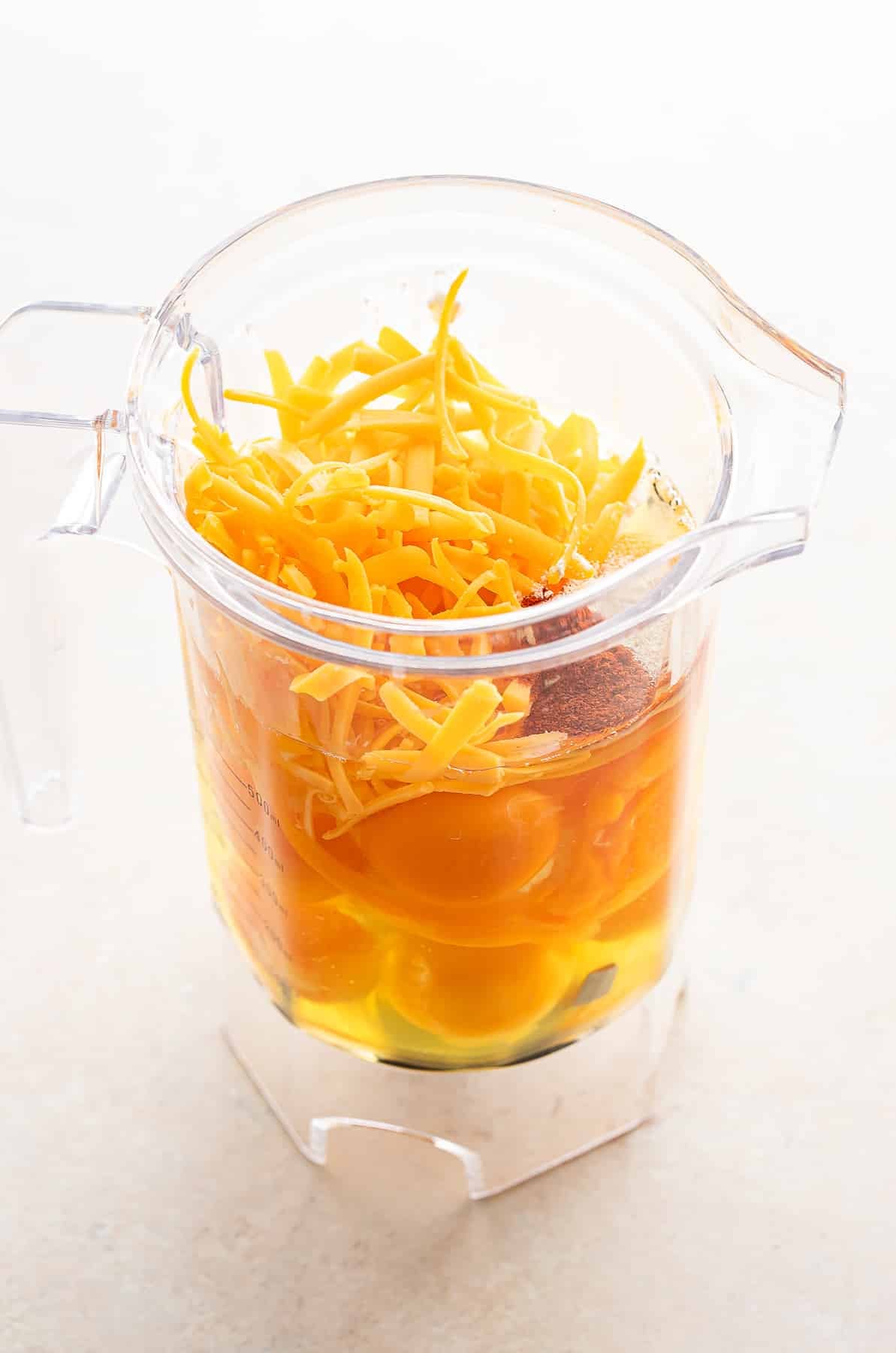 Ingredients for egg bites in a blender jar before being blended together.
