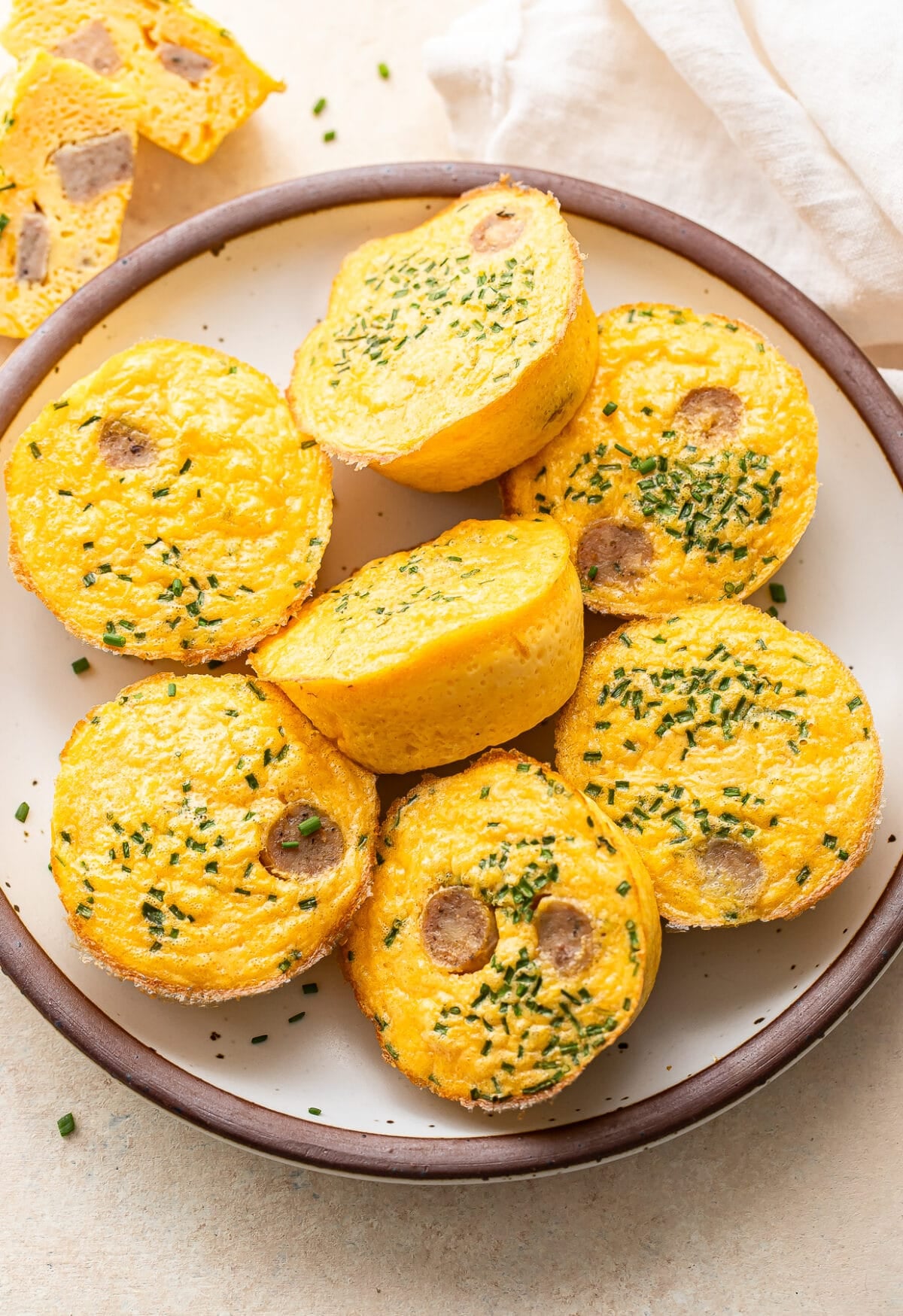Seven egg bites on a white plate.