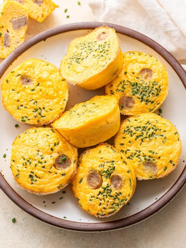 Seven egg bites on a white plate.