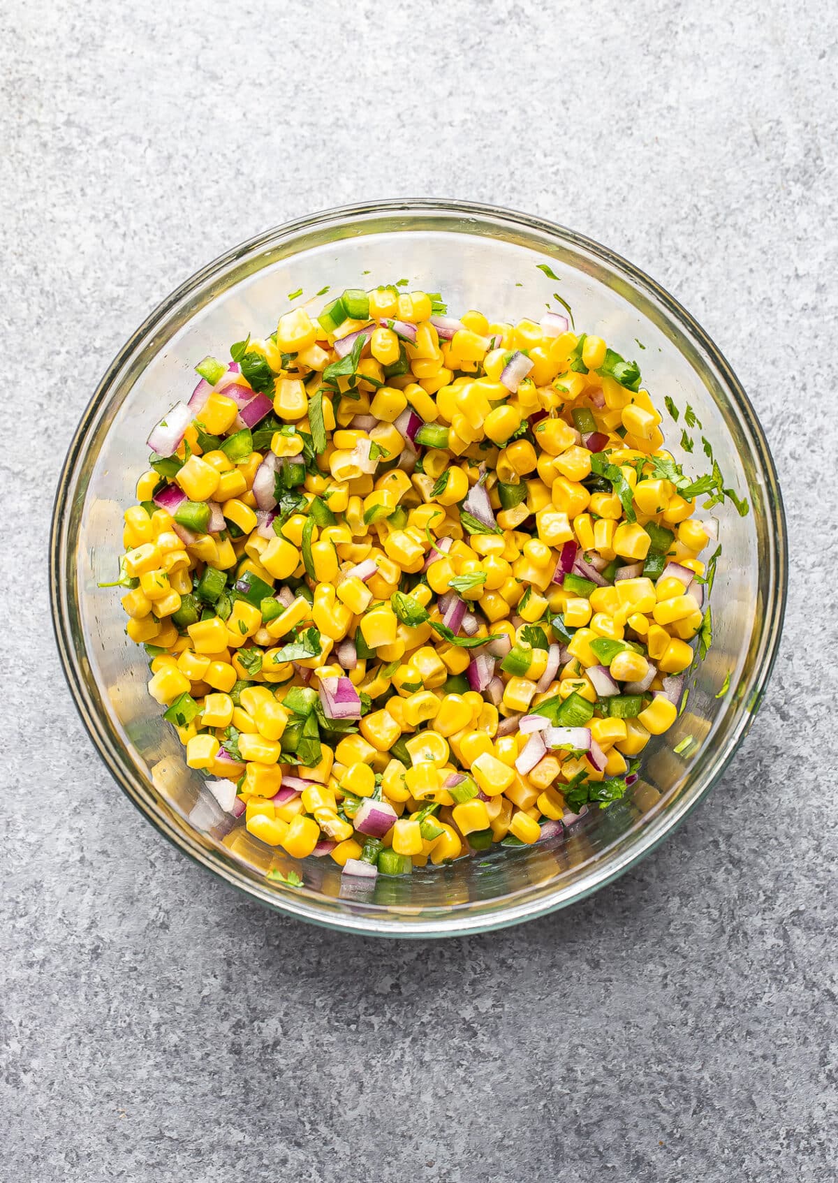 Corn salsa in a glass mixing bowl.