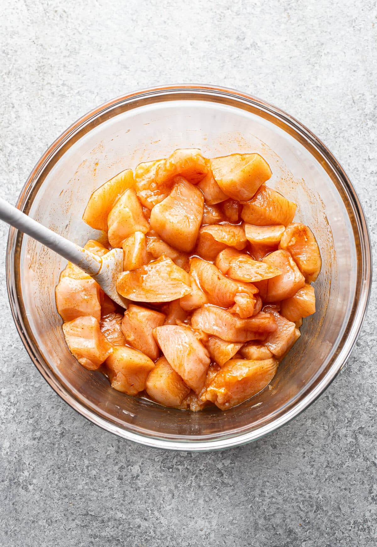 Chunks of raw chicken in the hot honey marinade.