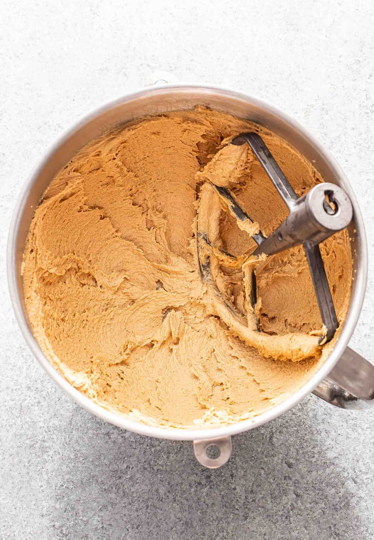 Butter, peanut butter and sugar mixture in a mixing bowl.