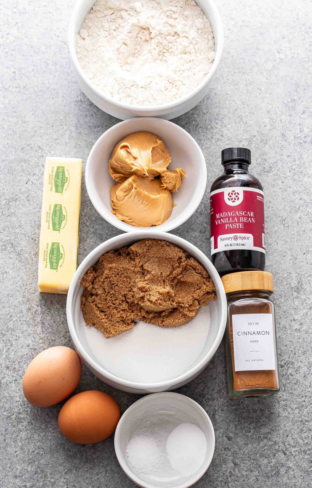 Ingredients used to make peanut butter cookies in white bowls.