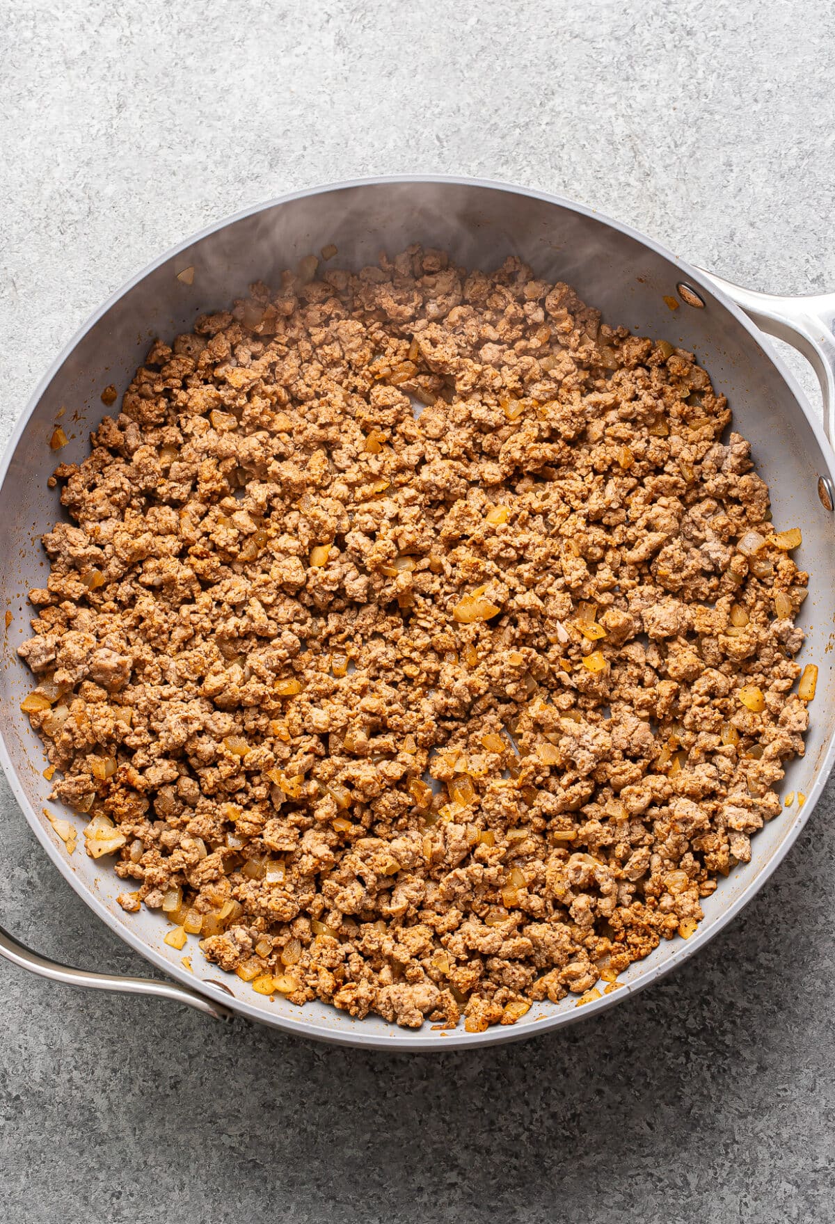Cooked ground turkey in a skillet.