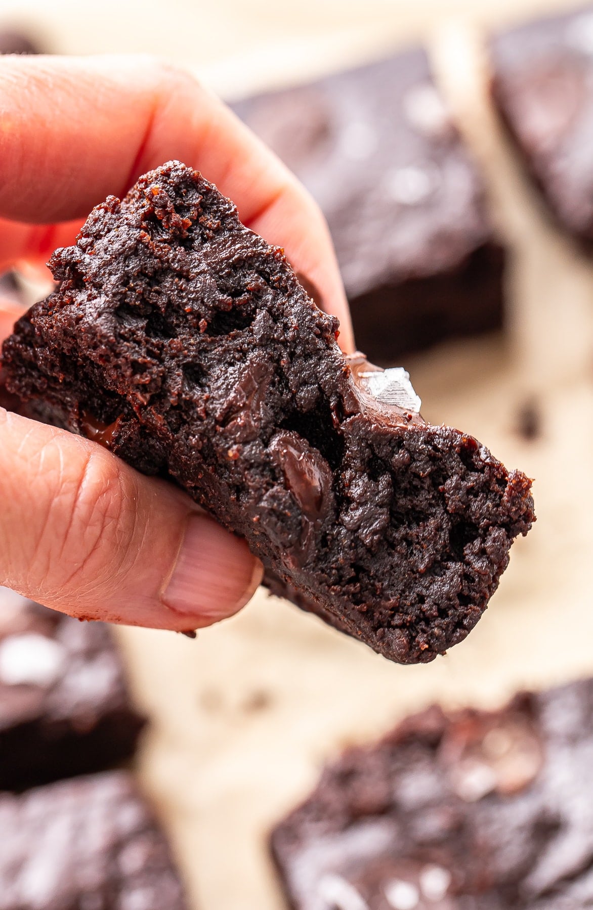 Hand holding a sweet potato brownie.