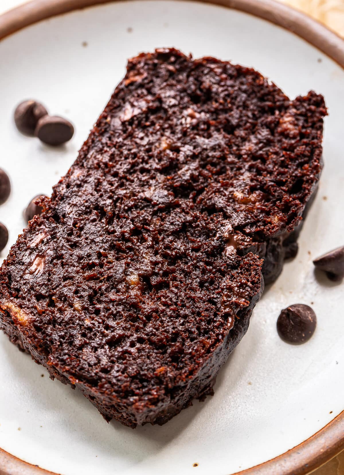 A slice of double chocolate banana bread on a white plate.