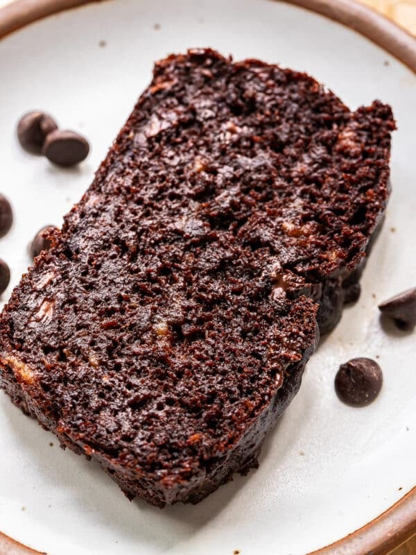 A slice of double chocolate banana bread on a white plate.