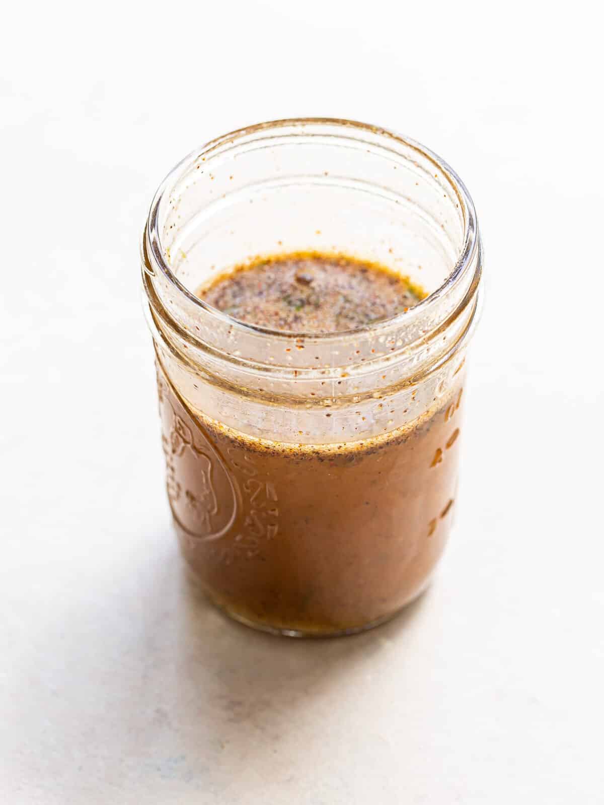 Honey lime vinaigrette in a glass jar.