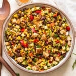 Southwest crispy rice salad with chicken, black beans, and corn in a white serving bowl.